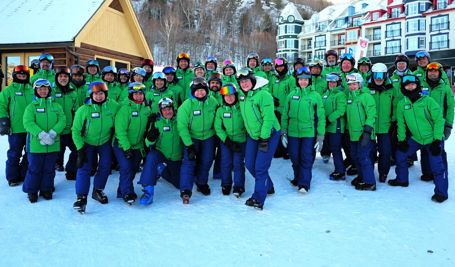 Group of ski instructors in green jackets